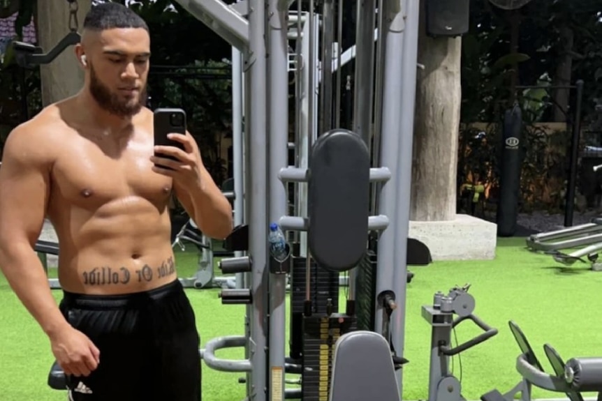 Anthony Pele shirtless in a gym