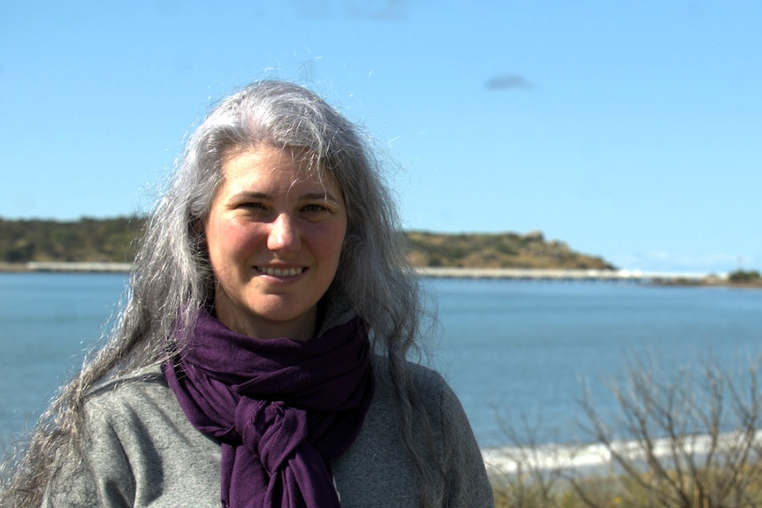 A woman with long hair. An island is in the background.