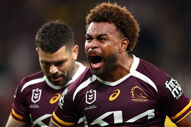 Ezra Mam of the Broncos celebrates a try with Adam Reynolds in the background.
