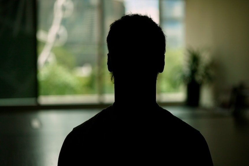 A silhouette of a person in a room
