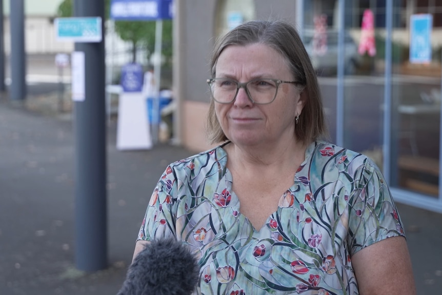 Huon voter Heather stands outside a school building.