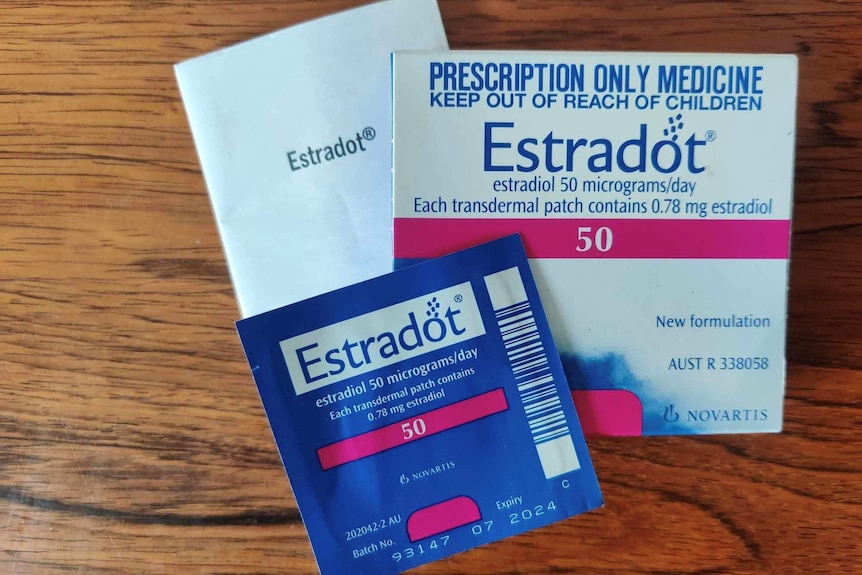 White box of medication sitting on wood table.