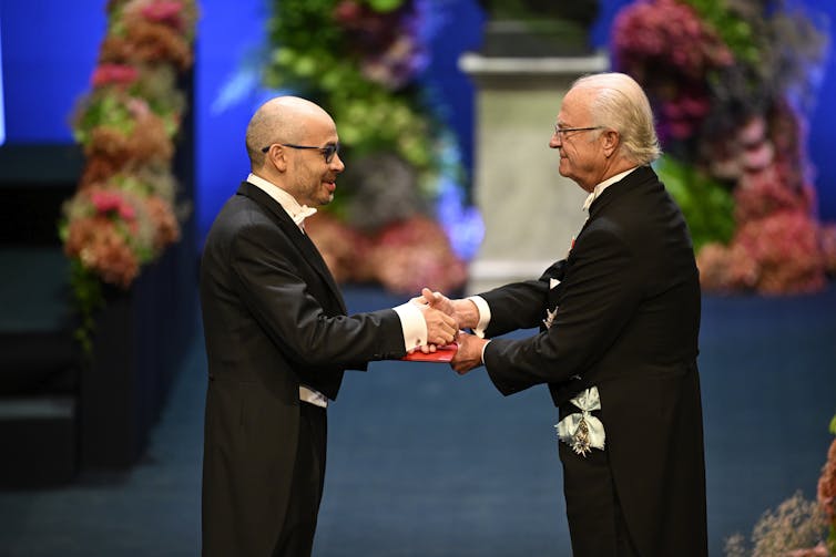 Demis Hassabis (left) and King Carl Gustaf of Sweden.