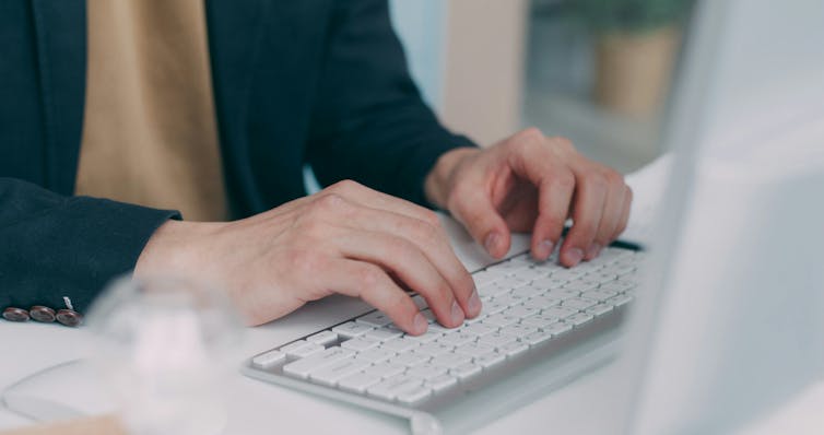 Person typing on a laptop keyboard