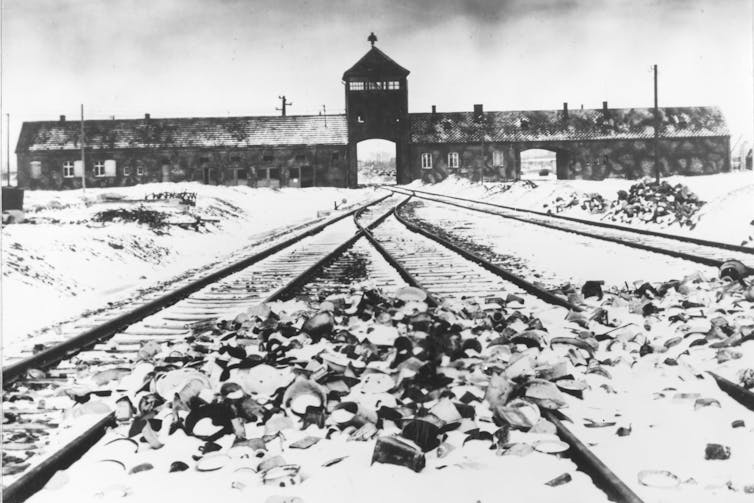 A old photograph of the entrance of a concentration camp.