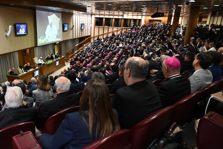 a screen and a large audience