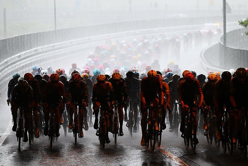 A general view of the peloton competing while it is raining heavily during the 109th Giro d'Italia 2026, Stage 5