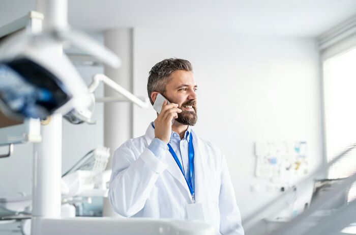 Smiling medical professional talking on phone in healthcare environment