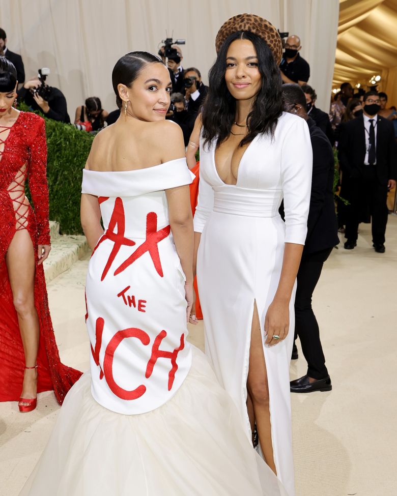 Alexandria Ocasio-Cortez, left, and designer Aurora James at the Met Gala in 2021. Ocasio-Cortez's dress, by James, reads