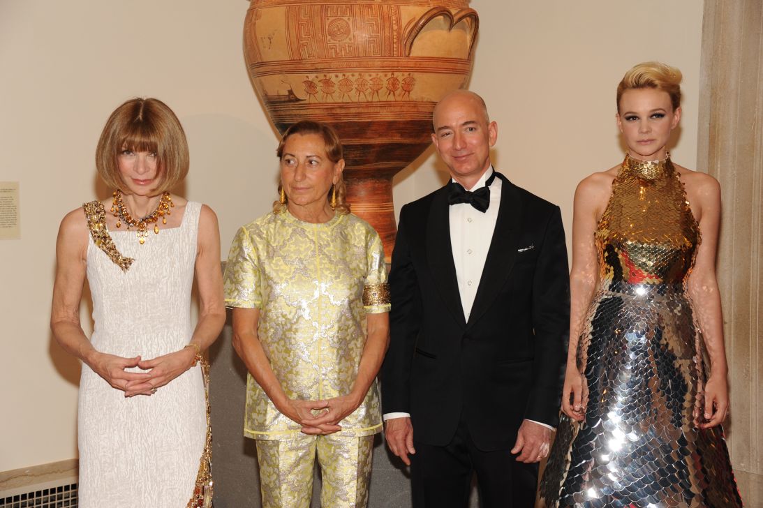In 2012, Amazon sponsored the Met Gala and Jeff Bezos served as honorary chair. He posed at that year's gala alongside Anna Wintour, Miuccia Prada and Carey Mulligan. (Photo by Steve Eichner/WWD/Penske Media via Getty Images)