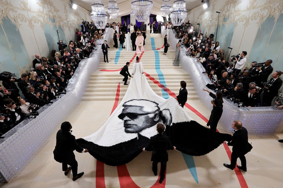 A guest's Karl Lagerfeld-themed cape is unfurled at the 2023 Met Gala. Lagerfeld, known for his Chanel designs and acerbic judgments, was the center of that year's exhibition.