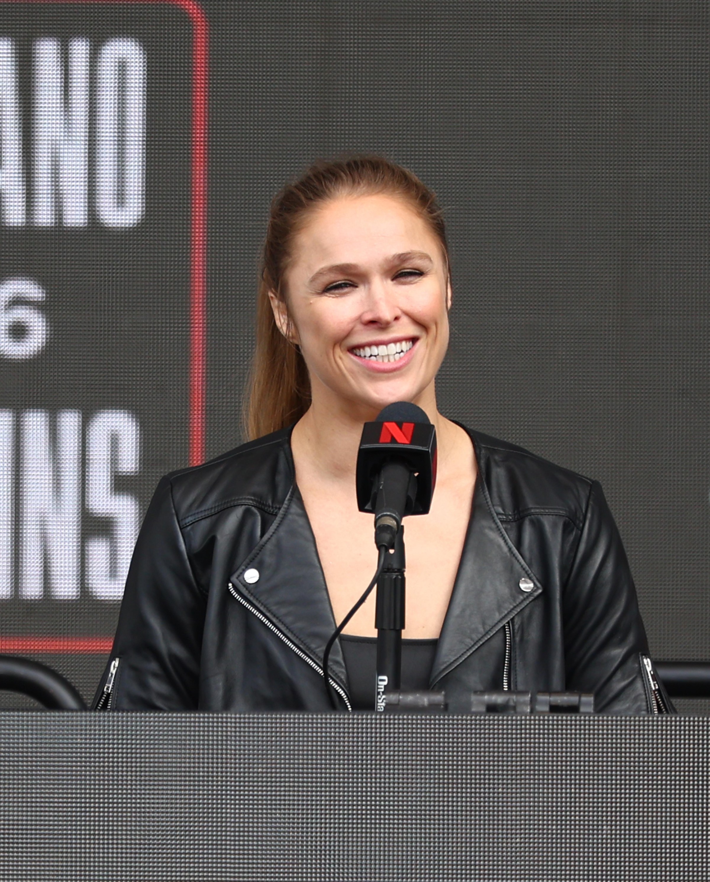 INGLEWOOD, CALIFORNIA - MARCH 10: Ronda Rousey speaks onstage during Netflix’s Ronda Rousey x Gina Carano Los Angeles MMA Press Conference at Intuit Dome on March 10, 2026 in Inglewood, California. (Photo by Melina Pizano/Getty Images for Netflix)