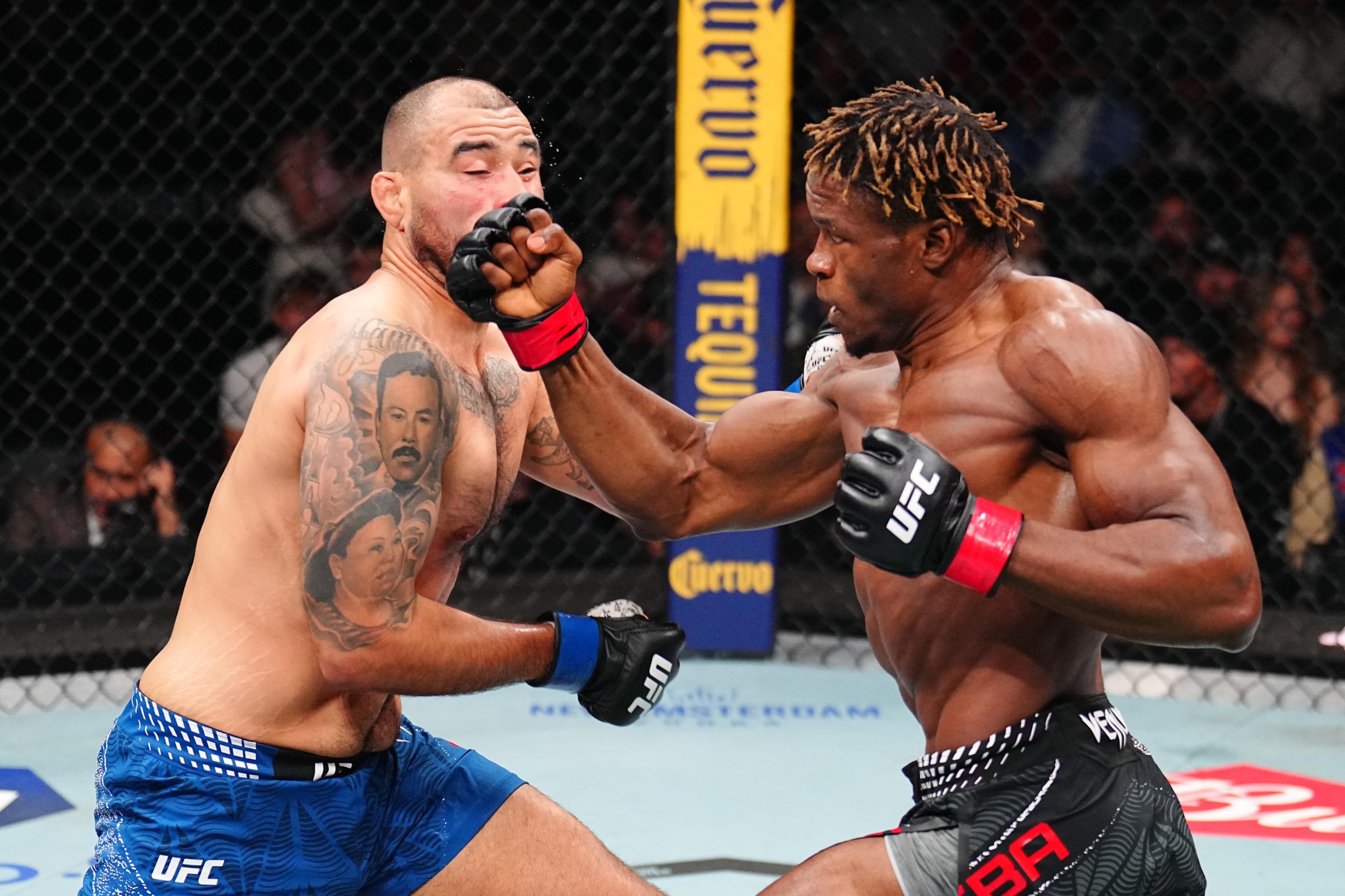 NEWARK, NEW JERSEY - MAY 09: (R-L) Ateba Gautier of Cameroon punches Ozzy Diaz in a middleweight fight during the UFC 328 event at Prudential Center on May 09, 2026 in Newark, New Jersey. (Photo by Chris Unger/Zuffa LLC)
