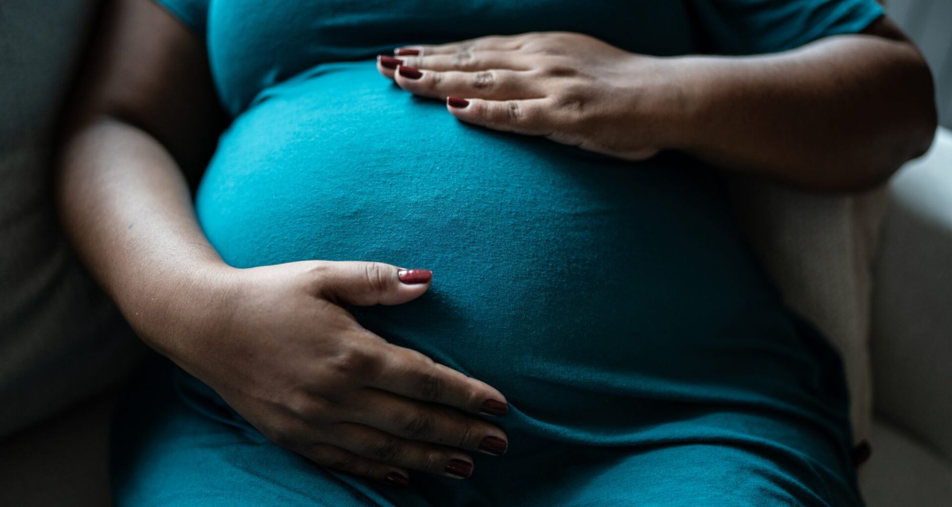 Pregnant woman touching her belly