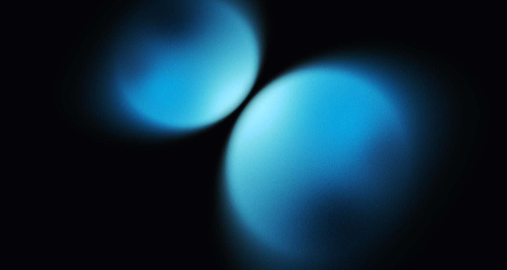 Two blue spheres coming closer together