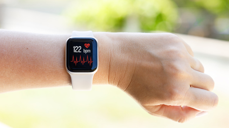 a smartwatch tracking heart rate on a wrist