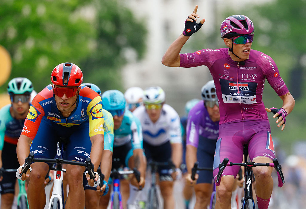 Soudal Quick-Step French rider Paul Magnier (R) wearing the points classification mauve jersey (Maglia Ciclamino) celebrates as he crosses the finish line next to Lidl - Trek Italian rider Jonathan Milan to win the 3nd stage of the Giro d'Italia 2026 - Tour of Italy cycling race between Plovdiv and Sofia, Bulgaria, on May 10, 2026. (Photo by Luca Bettini / AFP)
