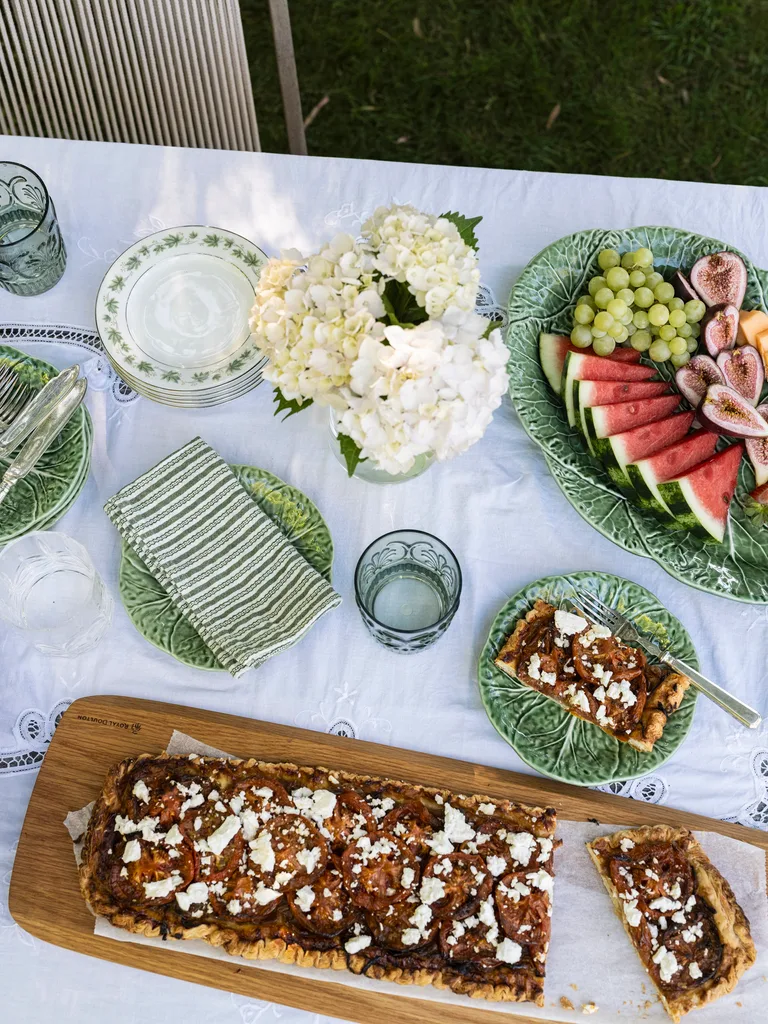 A table with a feta tart and fruit platter