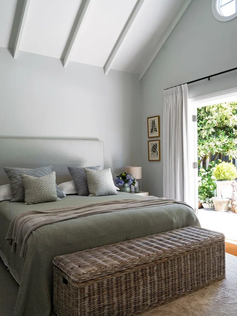 A country-style bedroom with a rattan storage basket
