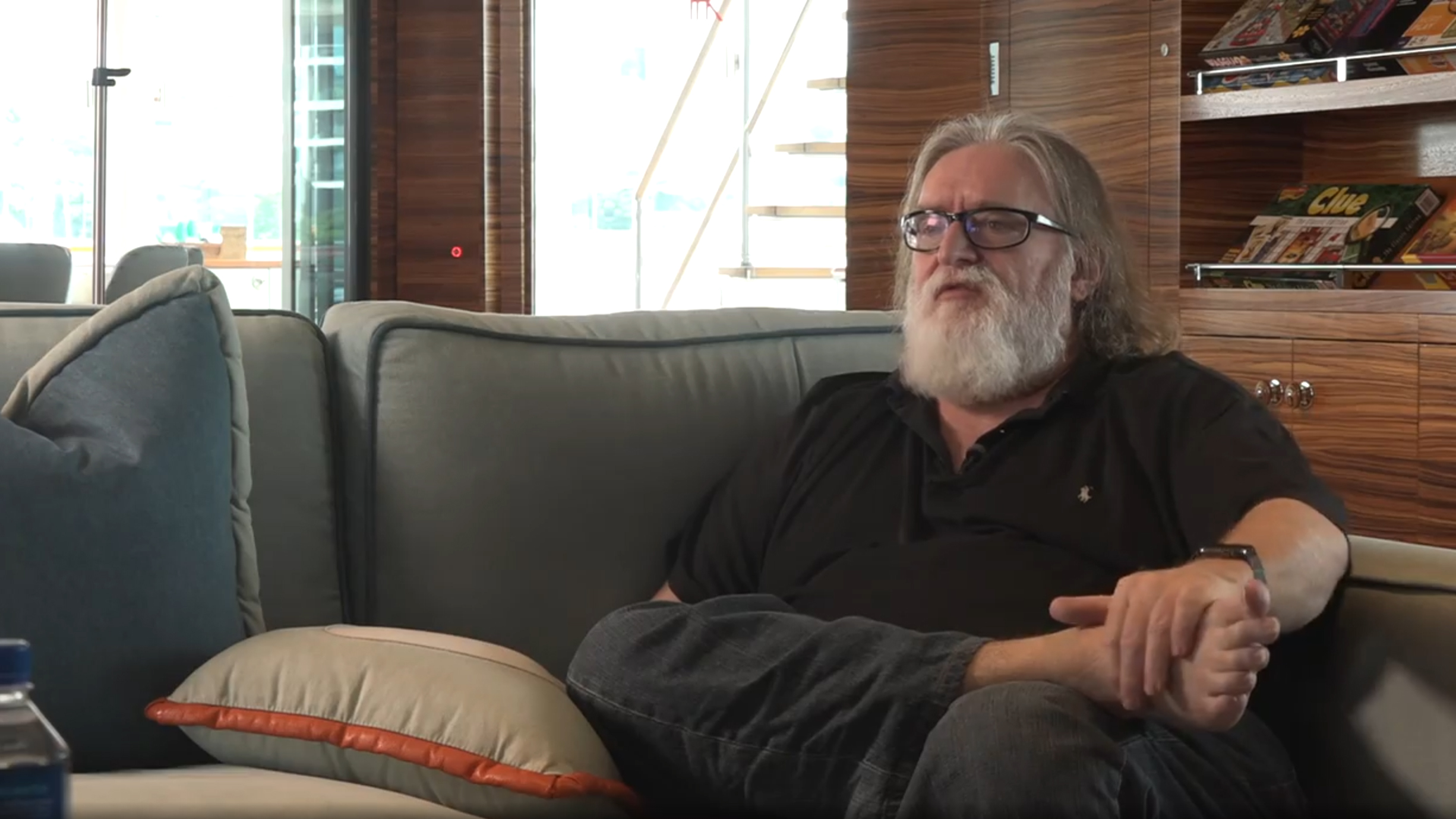 Gabe Newell sat on a sofa, barefoot, talking about brain-computer interface technology