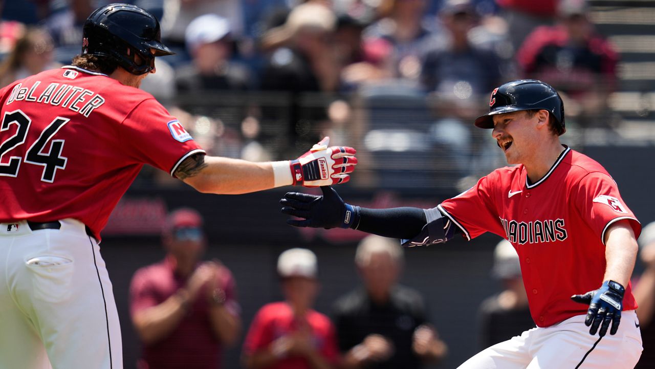 Cleveland Guardians' Kyle Manzardo, right, is congratulated by Chase DeLauter (24) after hitting a home run in the third inning of a baseball game against the Cincinnati Reds in Cleveland, Sunday, May 17, 2026.