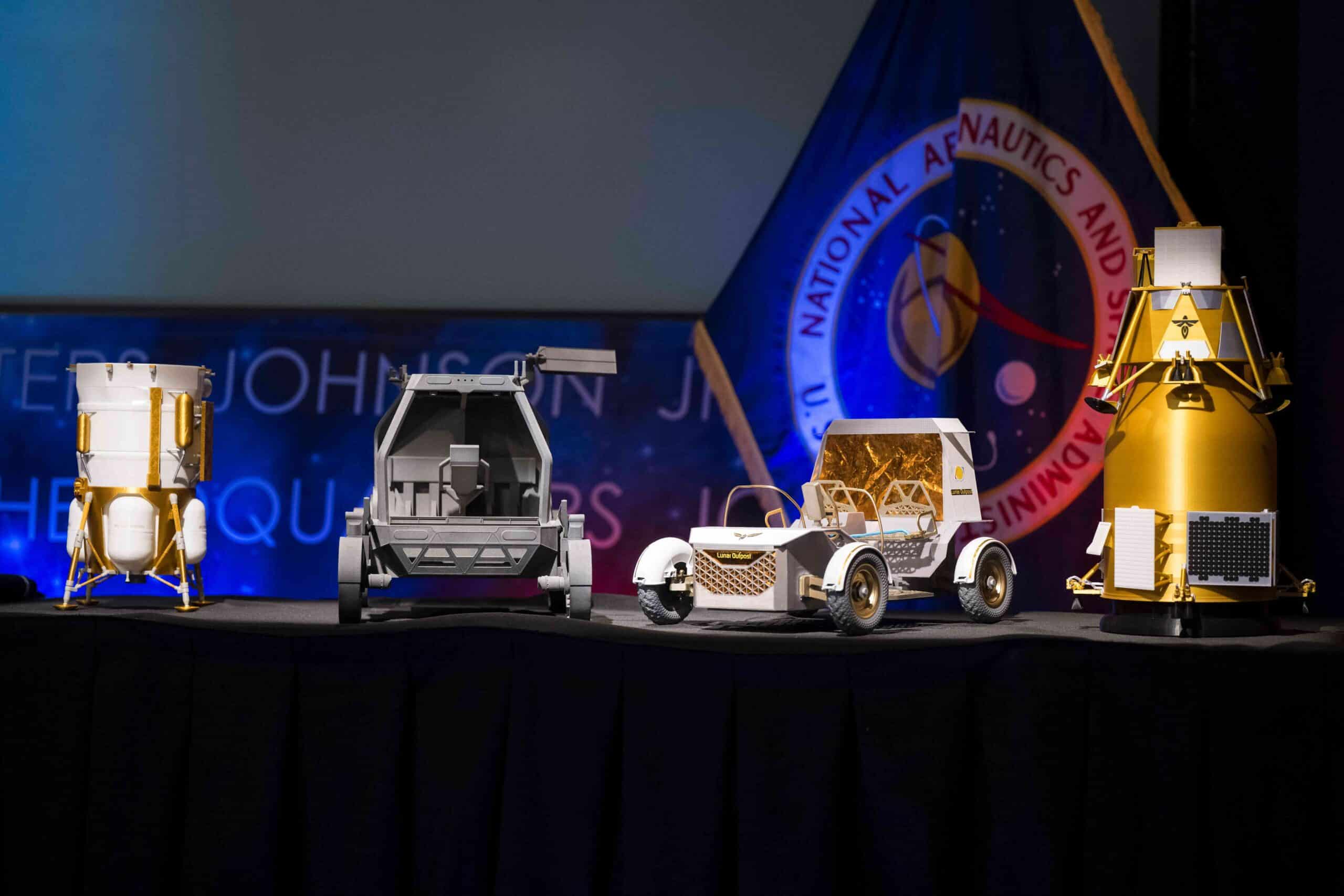 From left to right, models of the Blue Origin Mark 1 Lunar Lander, Astrolab Crewed Lunar Rover, Lunar Outpost Pegasus rover, and the Firely Elytra Dark orbiter