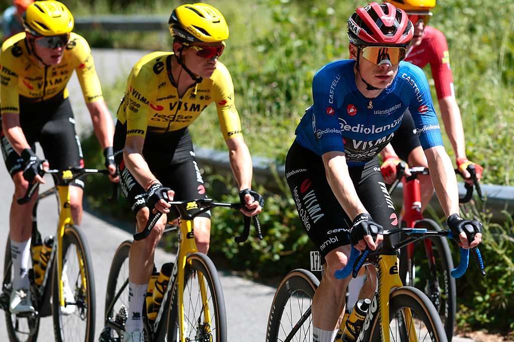 Team Visma Lease a Bike Danish rider Jonas Vingegaard (R) wearing the best climber's blue jersey (Maglia Azzura) rides in the pack during the 11th stage of the Giro d'Italia 2026 - Tour of Italy cycling race between Porcari and Chiavari, Italy, on May 20, 2026. (Photo by Luca Bettini / AFP)
