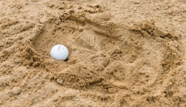 A ball in a footprint in an unraked bunker