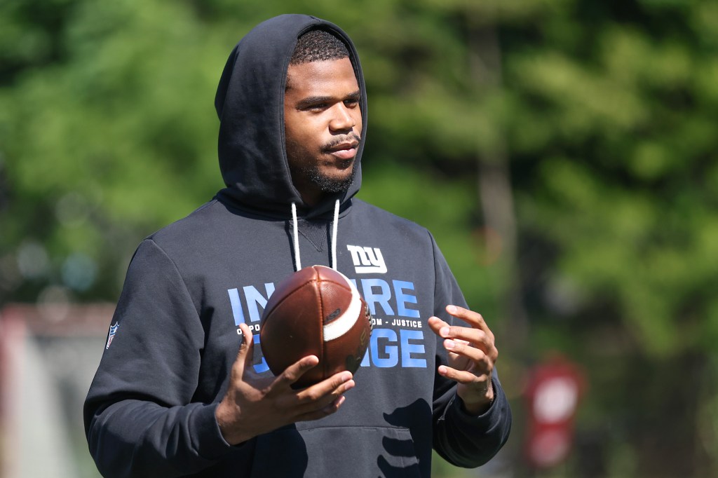New York Giants linebacker Abdul Carter listens to instructions during his football camp at Fordham Prep.