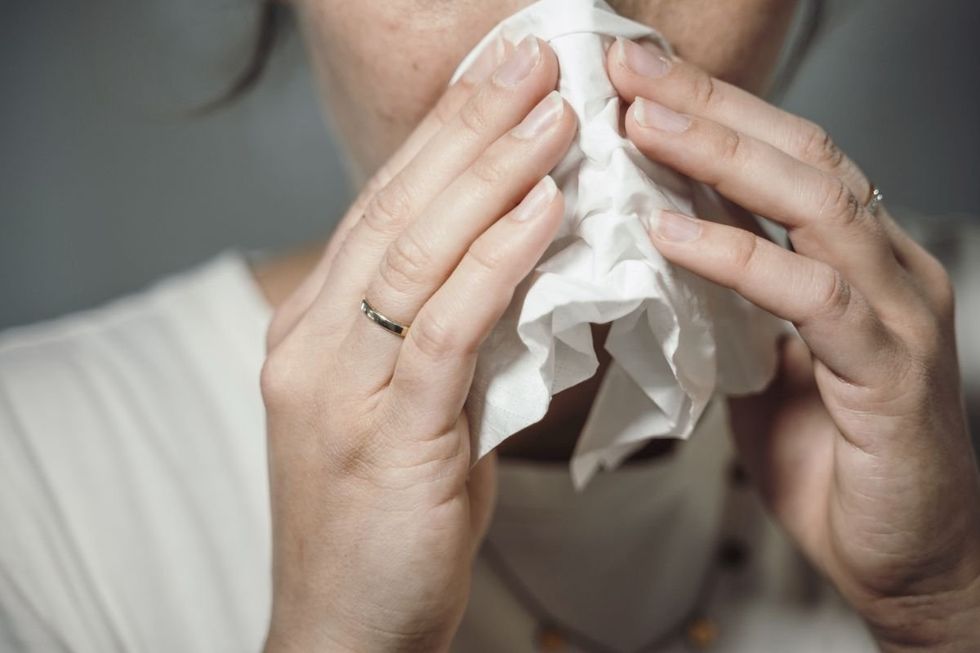 PERSON BLOWING NOSE