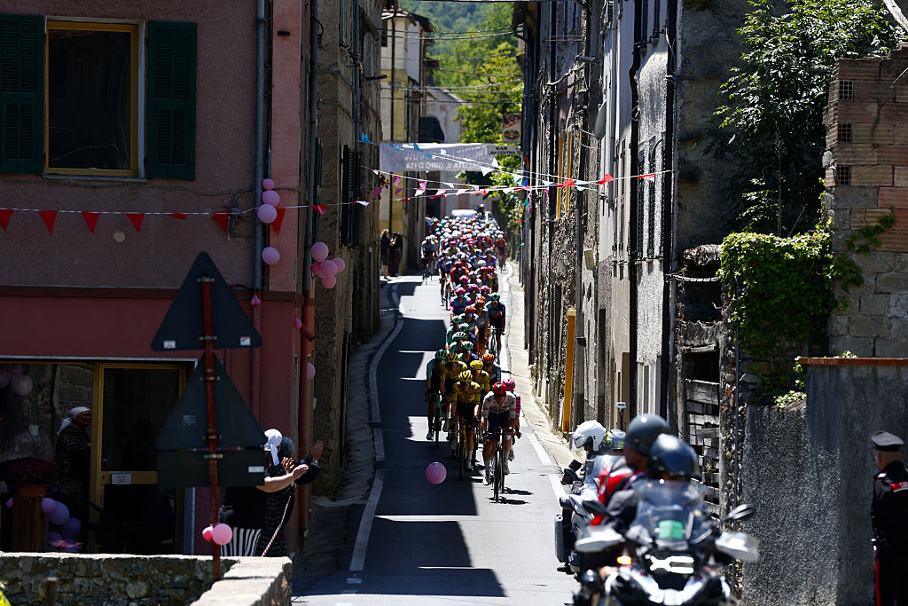 The Peloton rides in Borghetto d'Arroscia during the 12th stage of the Giro d'Italia 2026 - Tour of Italy cycling race between Imperia and Novi Ligure, Italy, on May 21, 2026. (Photo by Luca Bettini / AFP)
