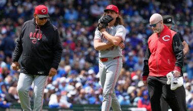 Cincinnati Reds starting pitcher Rhett Lowder, center, leaves with manager Terry Francona, left, and a team trainer after an injury during the fourth inning of a baseball game against the Chicago Cubs in Chicago, Thursday, May 7, 2026. (AP Photo/Nam Y. Huh)