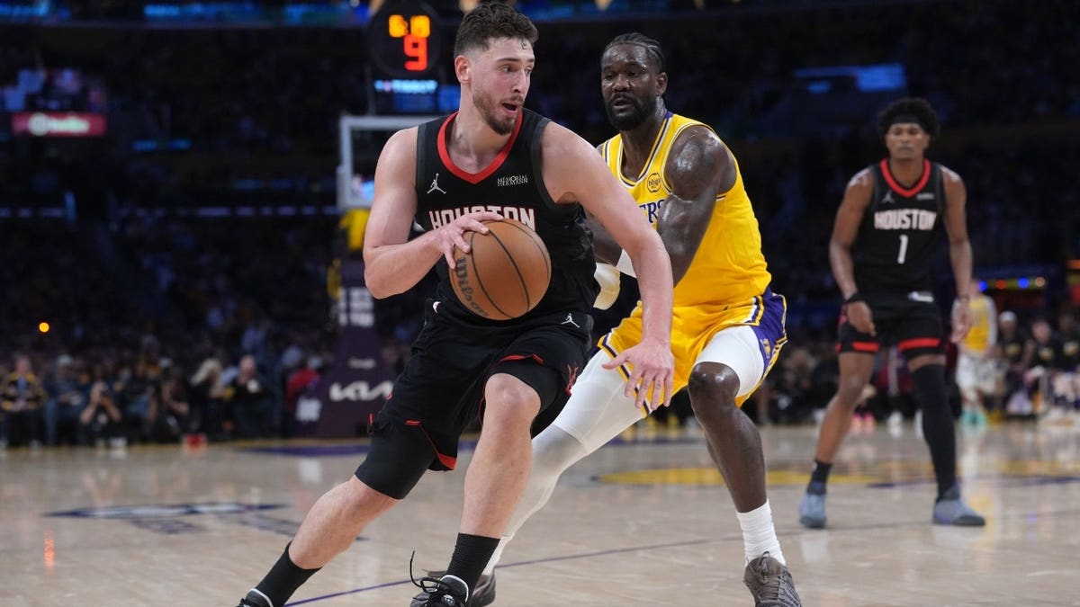 Houston Rockets center Alperen Sengun drives to the basket on Los Angeles Lakers C Deandre Ayton in Game 1 of the first round of the 2026 NBA Playoffs at Crypto.com Arena.