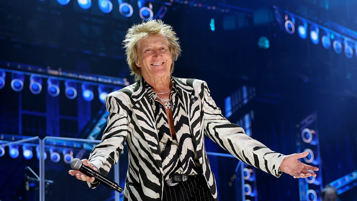 Rod Stewart performing onstage in zebra print at FireAid benefit concert in Inglewood