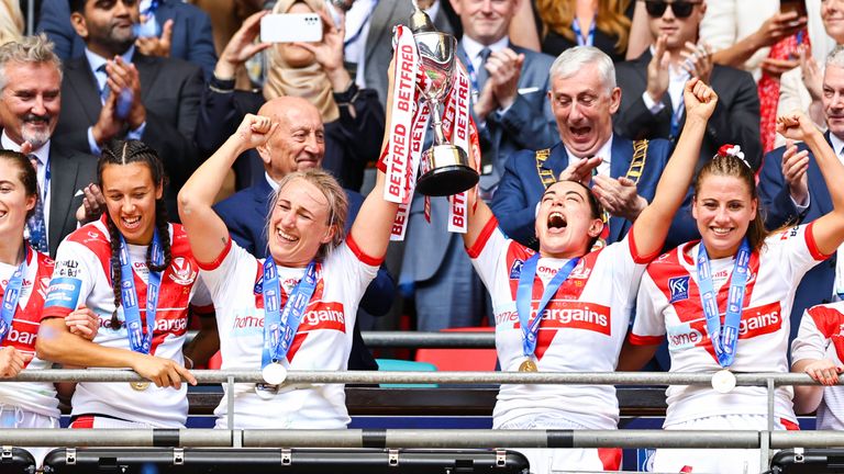 Jodie Cunningham and Emily Rudge of StHelens lift the Challenge Cup Trophy