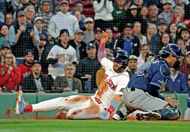 Boston Red Sox shortstop Trevor Story, left, slides safely past Tampa Bay Rays catcher Nick Fortes during the third inning at Fenway Park. (Photo By Matt Stone/Boston Herald)