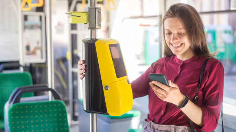 A person paying using a smartphone to pay for public transport