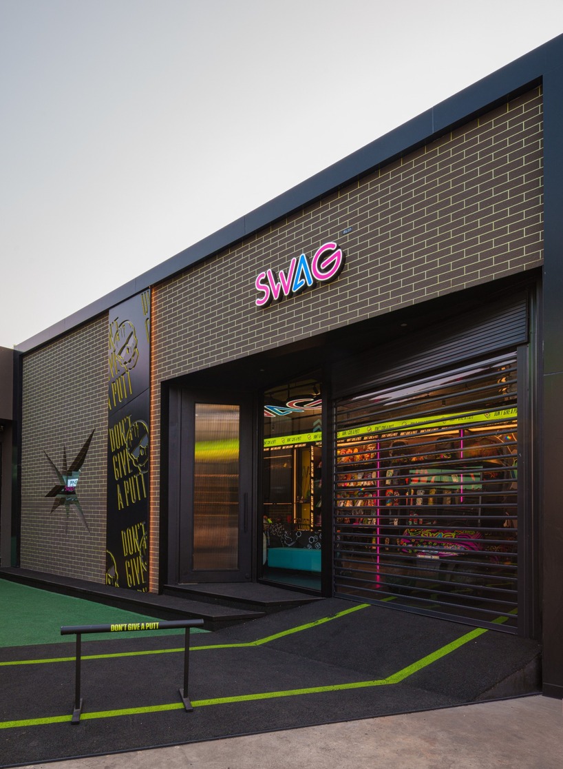 monochrome surfaces and neon accents outline swag golf bangkok flagship - 3
