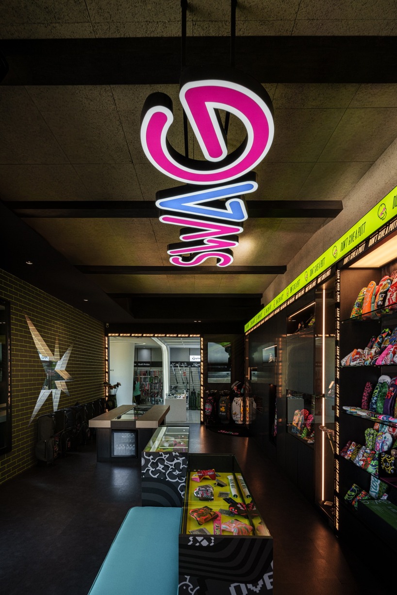 monochrome surfaces and neon accents outline swag golf bangkok flagship - 6