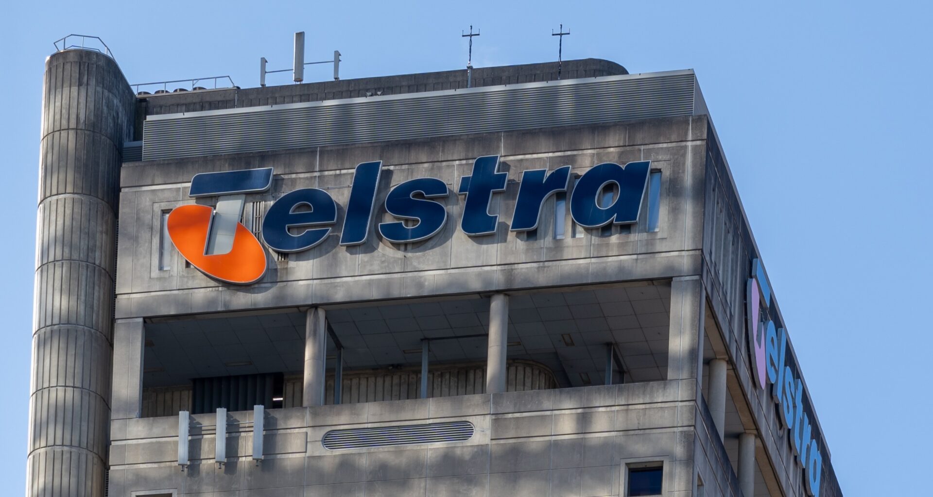 A close up of a large office building with the Telstra logo at the top.