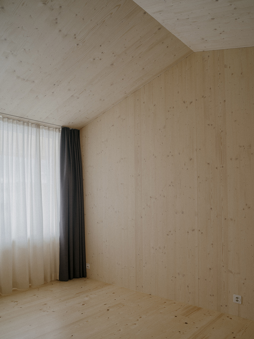 the tower house explores vertical living through prefabricated timber design 11
