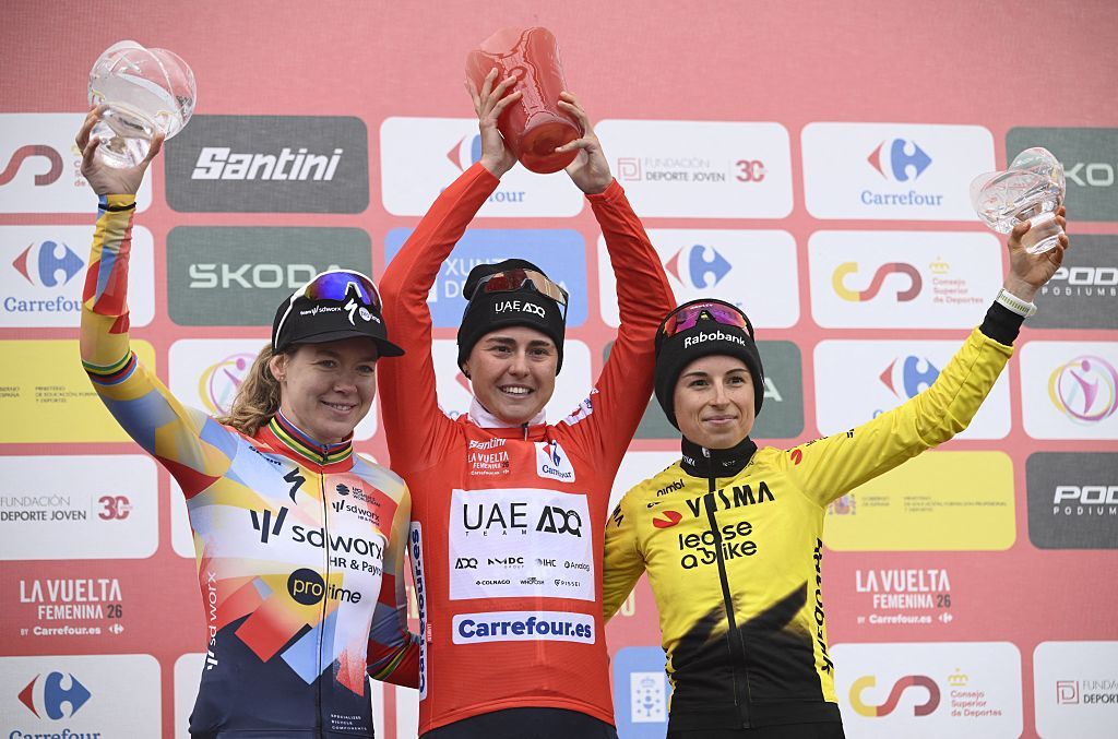 Winner of 2026 La Vuelta Femenina cycling tour of Spain, team UAE ADQ's Spanish rider Paula Blasi Cairol, second placed team SD Worx - Protime's Dutch rider Anna van der Breggen (L) and third placed Team Visma - Lease a Bike's French rider Marion Bunel (R) celebrate on the podium after the 7th stage, a 132.9 km race between Pola de Laviana and Alto de l'Angliru, on May 9, 2026. (Photo by Miguel RIOPA / AFP)