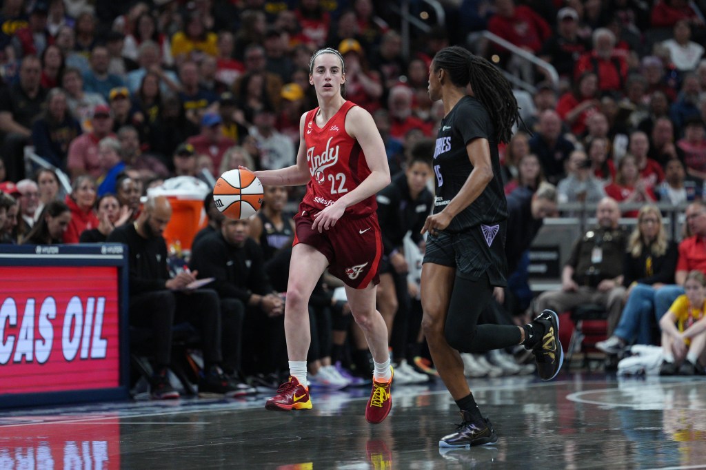 Caitlin Clark dribbling the ball during a WNBA game.