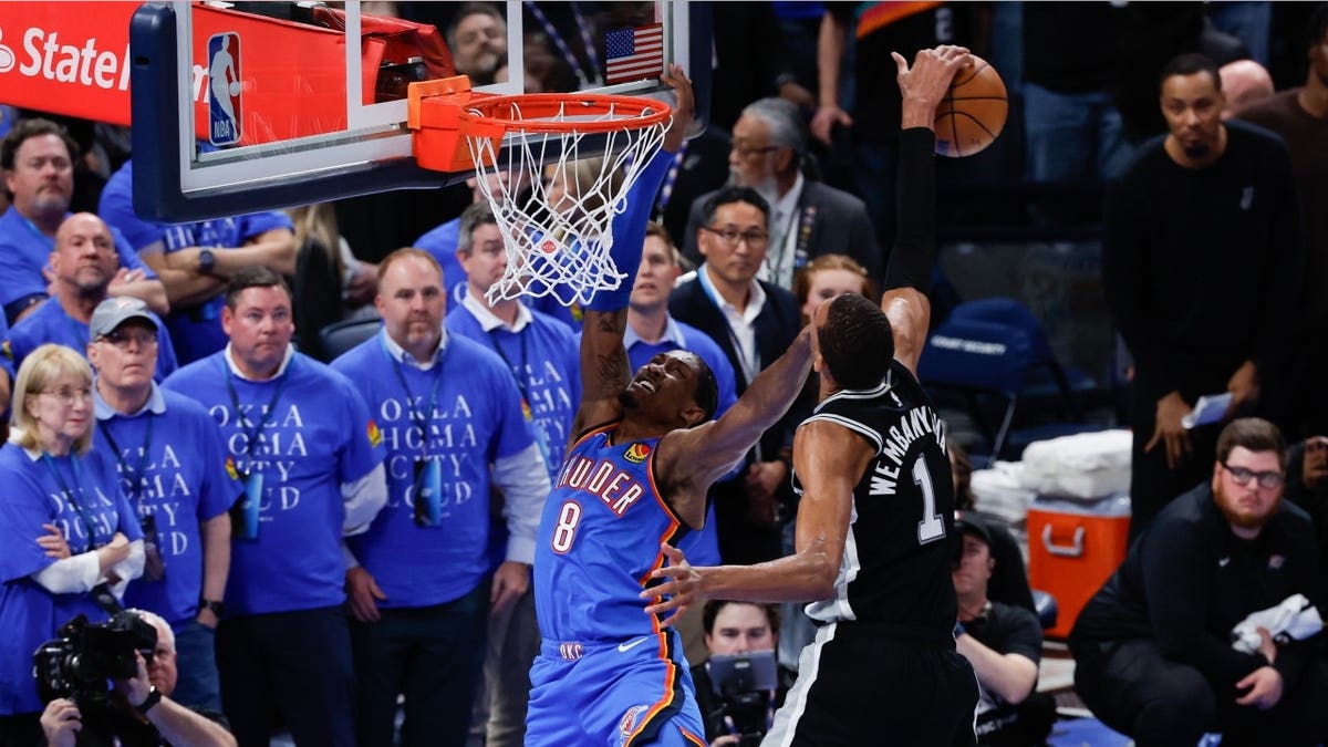 Victor Wembanyama blocks a shot by Jalen Williams during a basketball game.