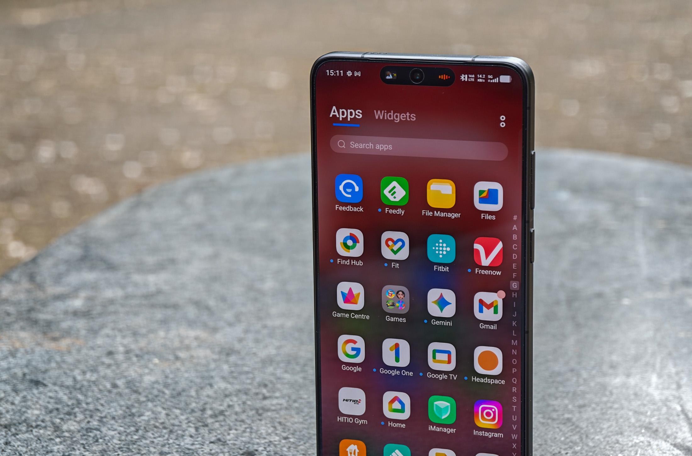 Photo of the Vivo X300 Ultra standing on a gray stone bench showing the app drawer with a spammy looking “Games” app included.
