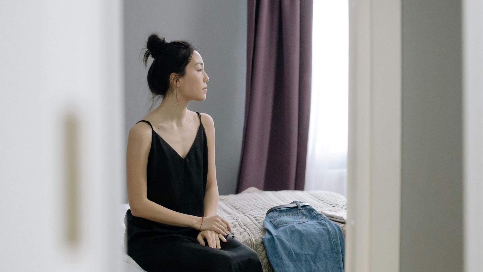 woman sitting in her bedroom