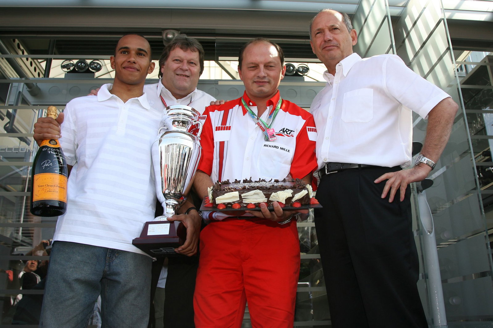 Hamilton celebrates his GP2 success with Fred Vasseur and Ron Dennis