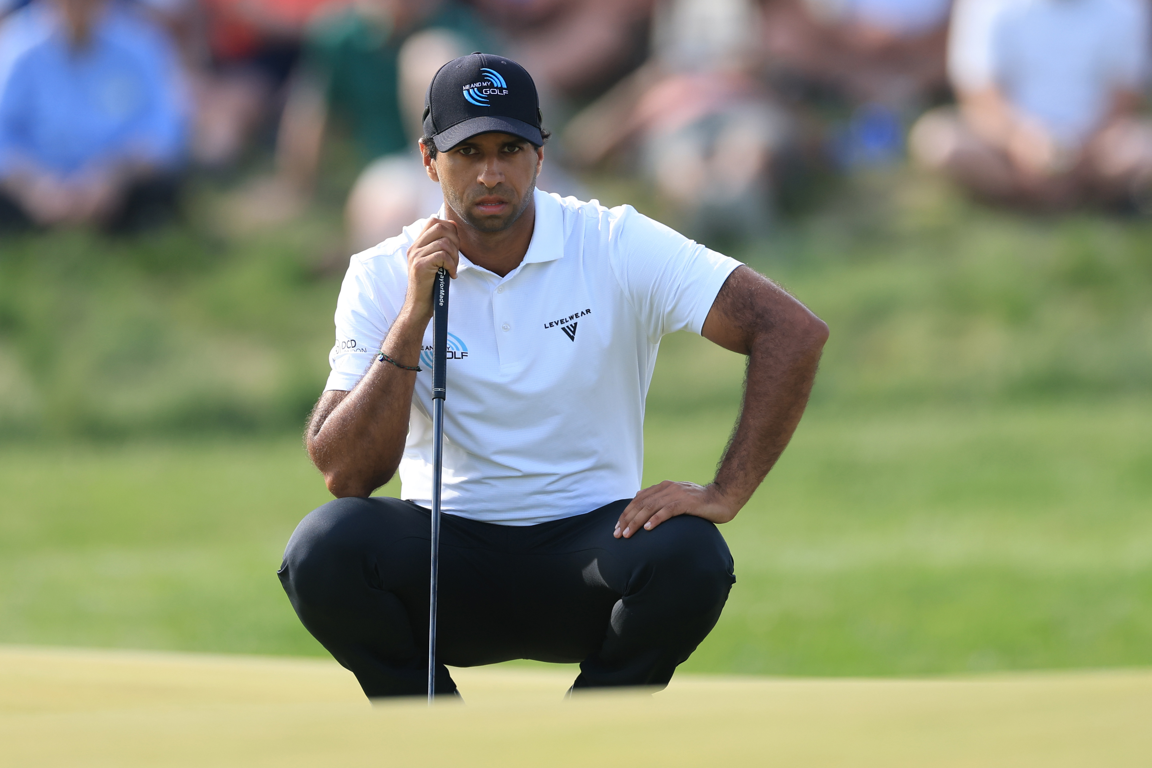 Aaron Rai of England lines up a putt on the 17th hole during the third round of the PGA Championship at Aronimink Golf Club