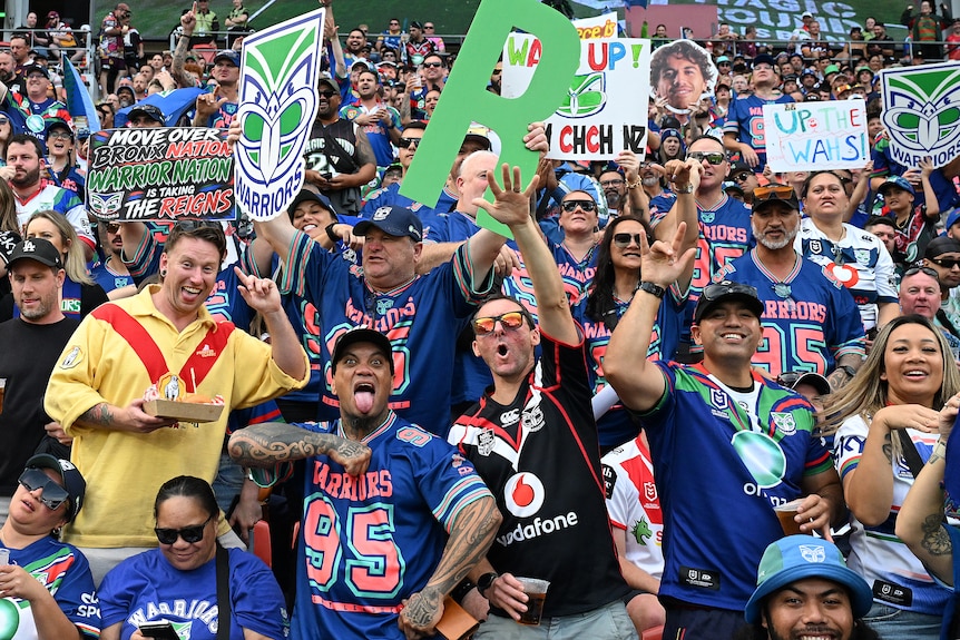 A group of Warriors fans celebrate a try