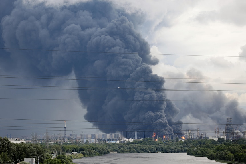 Thick plumes of smoke with flames rise from an oil refinery in Moscow